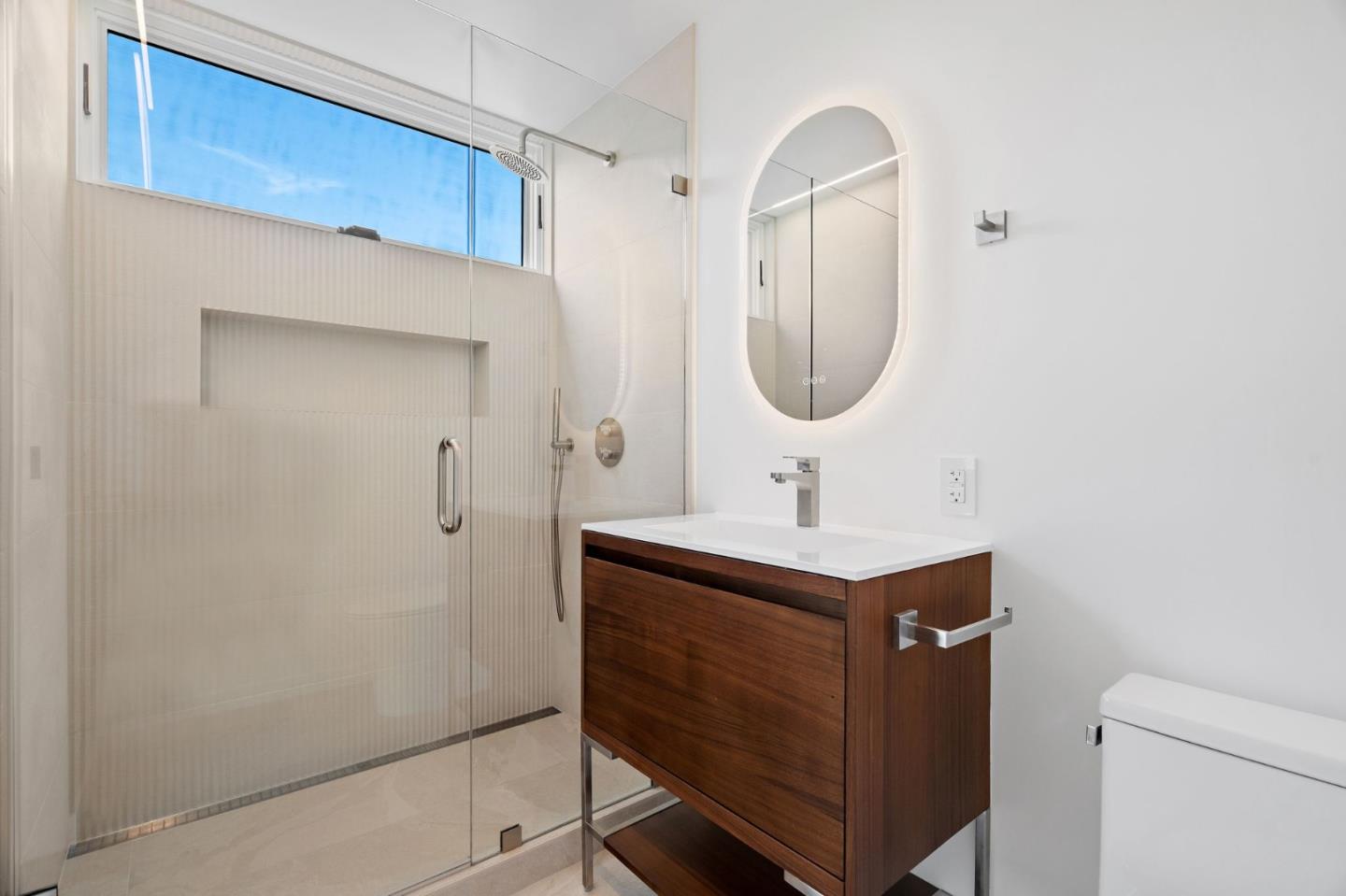 3886 Ross Road Palo Alto, CA 94303 - Photo 25 of 60 a bathroom with a sink a toilet and a mirror