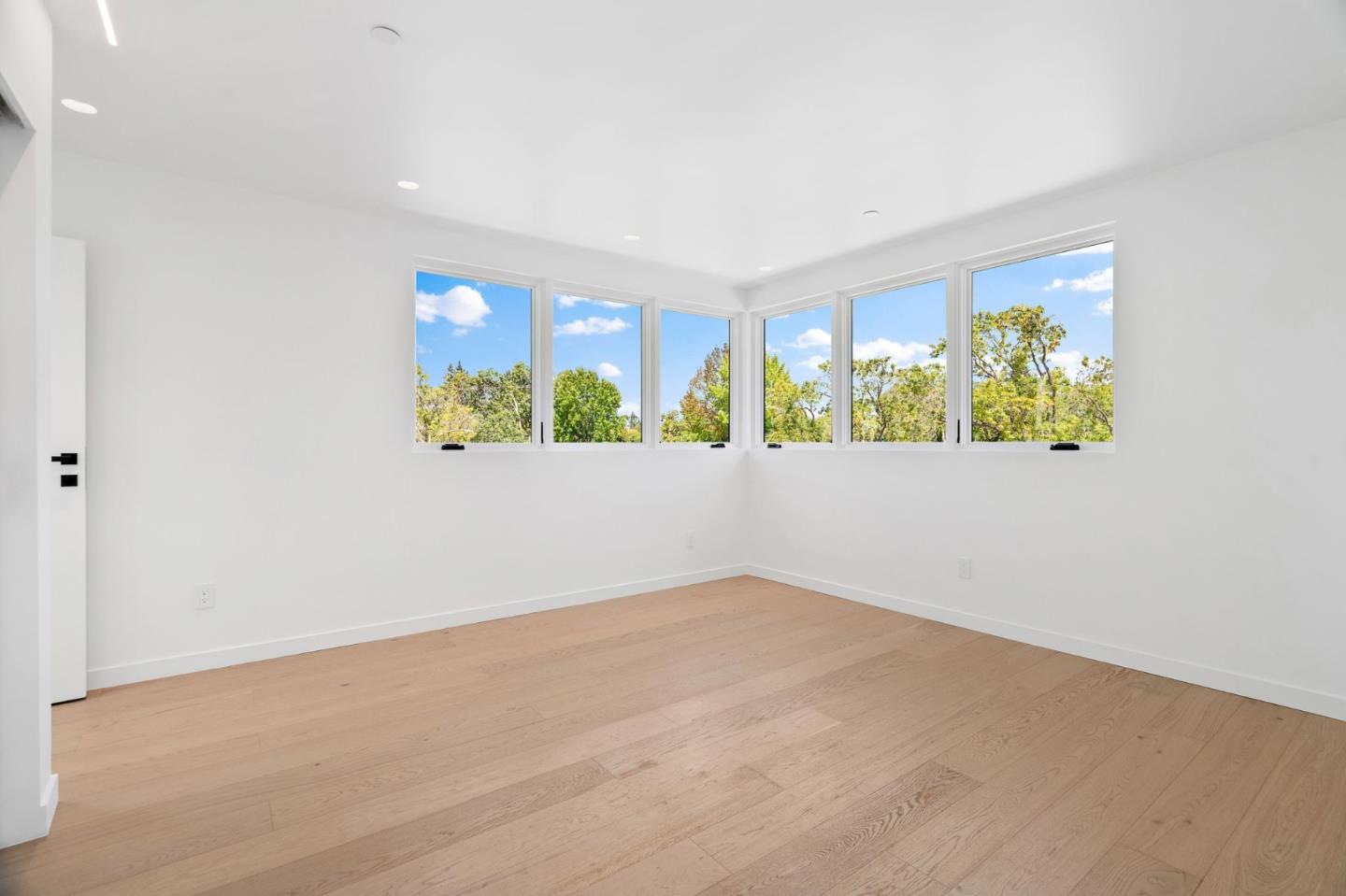 3886 Ross Road Palo Alto, CA 94303 - Photo 36 of 60 an empty room with windows and wooden floor