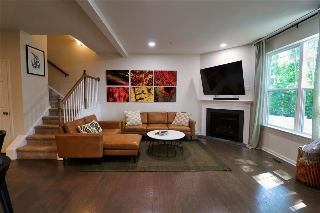 4502 Benjamin Court Emmaus, PA 18049 - Photo 14 of 53 Gleaming hardwood floors and a cozy fireplace create an inviting atmosphere in this spacious living area.
