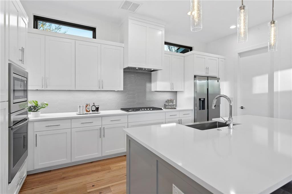 1004 Lott Avenue Austin, TX 78721 - Photo 13 of 39 a kitchen with a sink stainless steel appliances and cabinets
