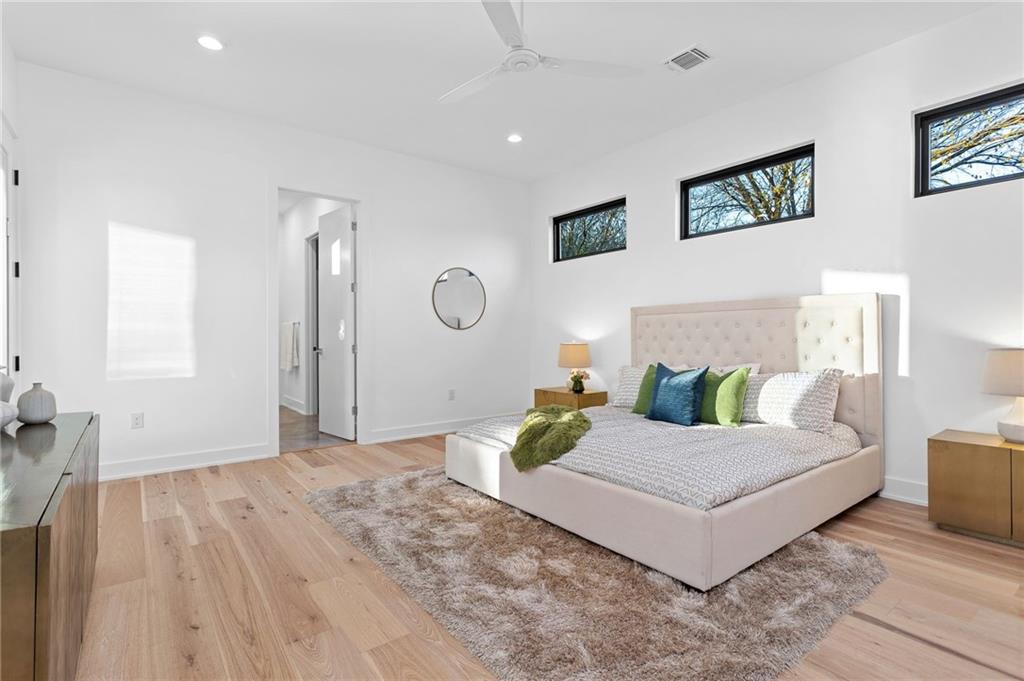 1004 Lott Avenue Austin, TX 78721 - Photo 20 of 39 a living room with a bed furniture and paintings on the wall