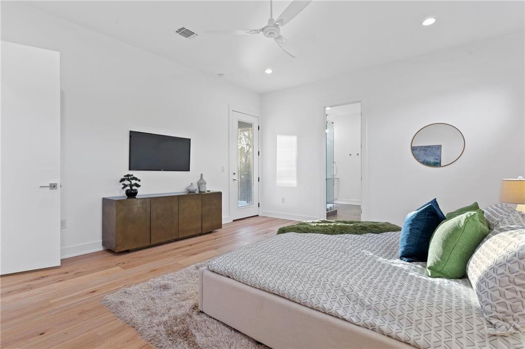 1004 Lott Avenue Austin, TX 78721 - Photo 21 of 39 a bedroom with a bed and a flat screen television