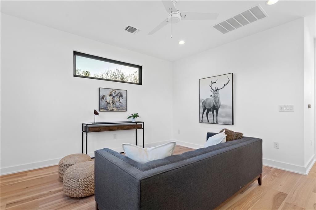 1004 Lott Avenue Austin, TX 78721 - Photo 25 of 39 a living room with furniture and a wooden floor