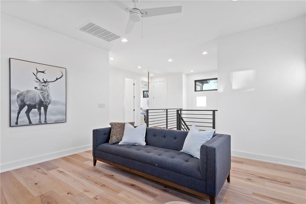 1004 Lott Avenue Austin, TX 78721 - Photo 26 of 39 a living room with furniture and a wooden floor
