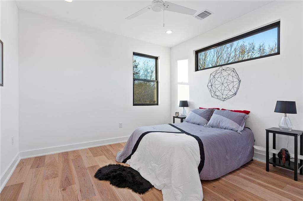 1004 Lott Avenue Austin, TX 78721 - Photo 30 of 39 a bedroom with a bed mirror and window