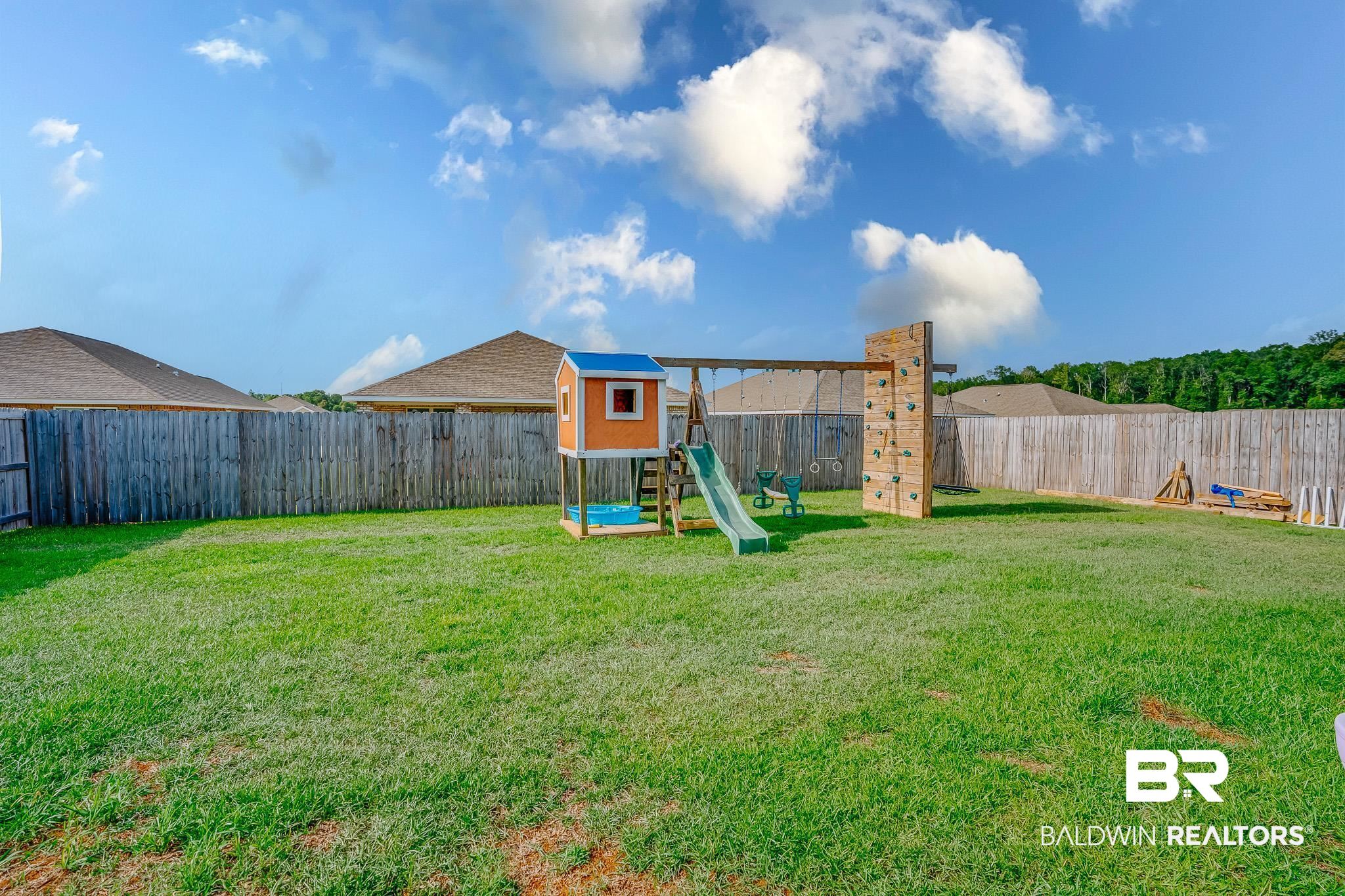 8242 Sycamore Way Semmes, AL 36575 - Photo 31 of 43 Fenced backyard with a playground