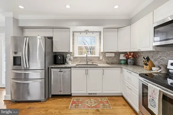 a living room with furniture large window and a fireplace