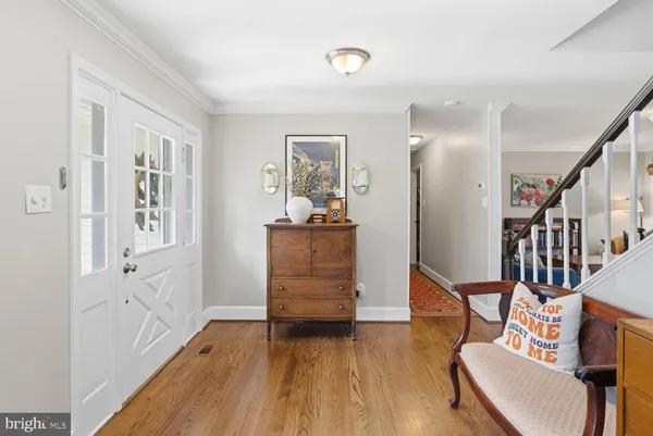 a view of a livingroom with furniture wooden floor and windows