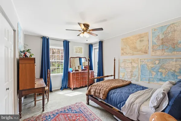 a bedroom with furniture and a book shelf