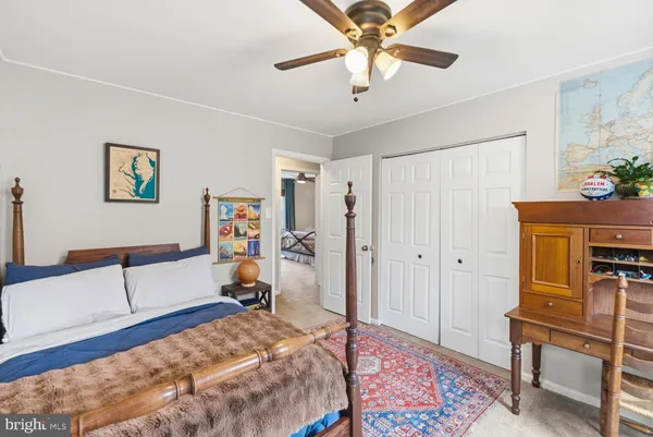 a bedroom with a bed and painting on the wall