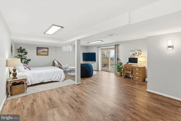 a balcony with wooden floor table and chairs