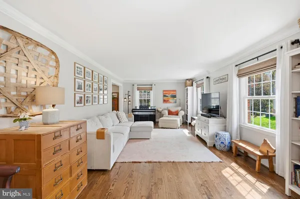 a living room with furniture and a dresser