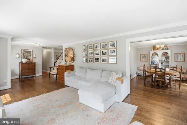 a living room with furniture and a book shelf