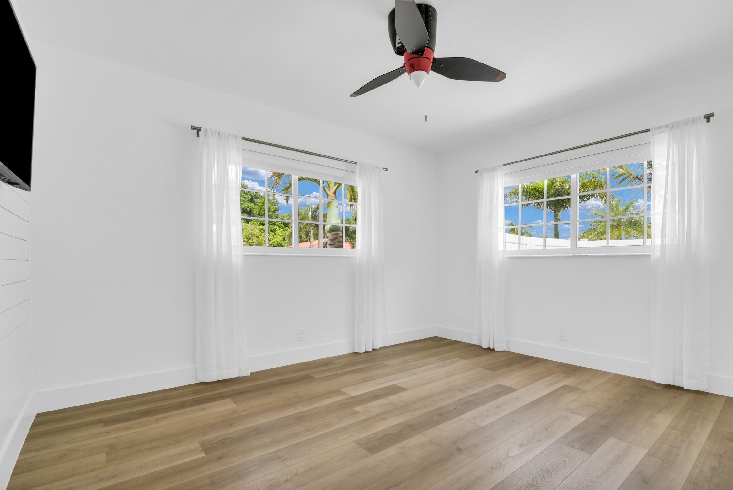 701 Appleby Street Boca Raton, FL 33487 - Photo 33 of 47 a view of an empty room with window and wooden floor