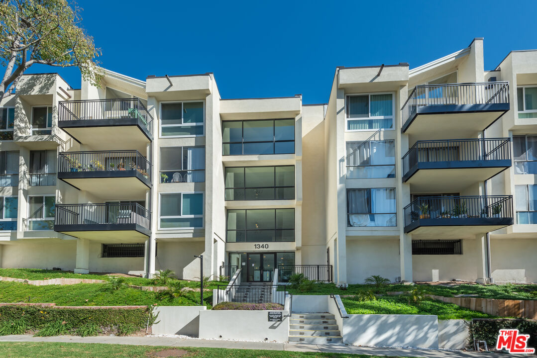 1340 South Beverly Glen Boulevard, Unit 307 Los Angeles, CA 90024 - Photo 15 of 18 a front view of a house with a yard