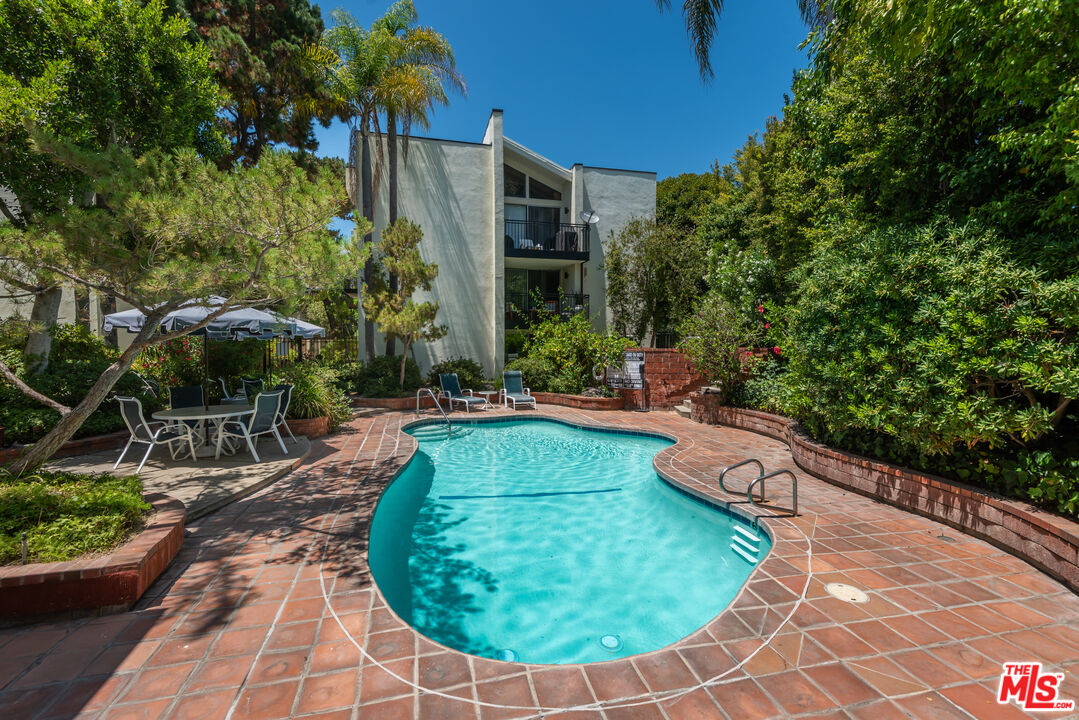 1340 South Beverly Glen Boulevard, Unit 307 Los Angeles, CA 90024 - Photo 16 of 18 a view of a backyard with plants and a patio