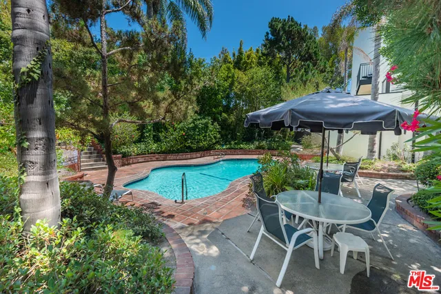 a view of a table and chairs under an umbrella