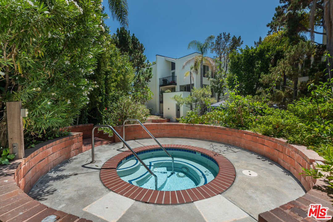 1340 South Beverly Glen Boulevard, Unit 307 Los Angeles, CA 90024 - Photo 18 of 18 a view of a swimming pool with a patio