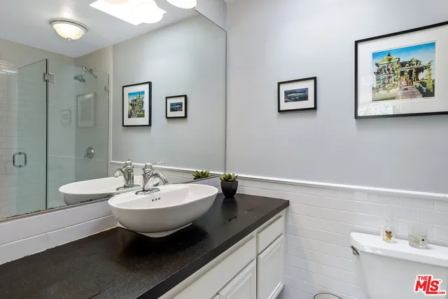 a spacious bathroom with a double vanity sink and a mirror