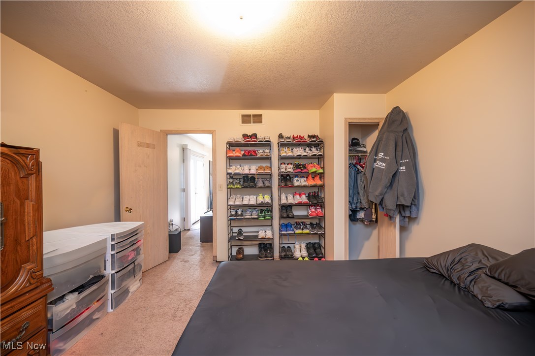 5546 Shaffer Road Northwest, Unit A & B Warren, OH 44481 - Photo 32 of 47 Bedroom featuring a textured ceiling, a closet, and light colored carpet