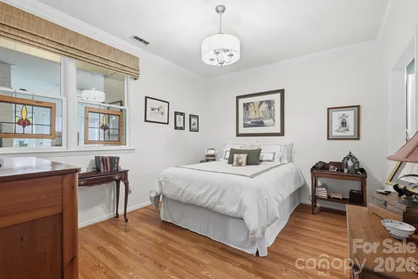 a bedroom with a bed and wooden furniture