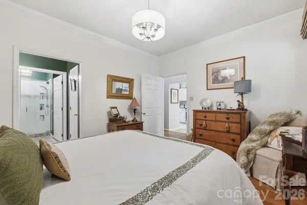 a bedroom with a bed and a chandelier