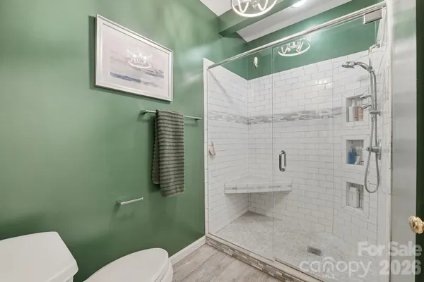 a bathroom with a toilet sink and shower