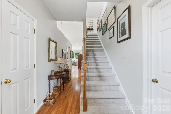 a view of entryway and hall with wooden floor