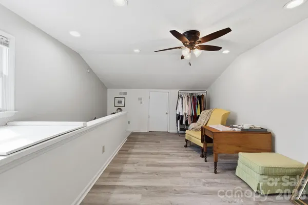 a living room with furniture and a ceiling fan