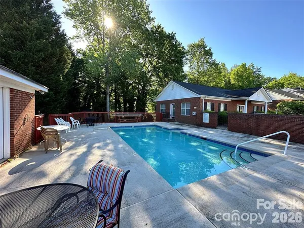 a view of swimming pool with chairs