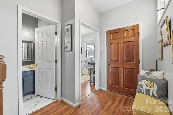 a view of a hallway with closet and wooden floor