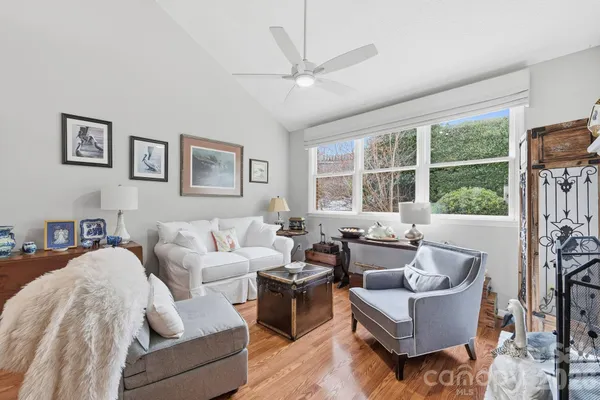 a living room with furniture and large windows