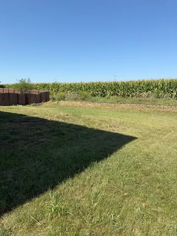 a view of a house with backyard and garden