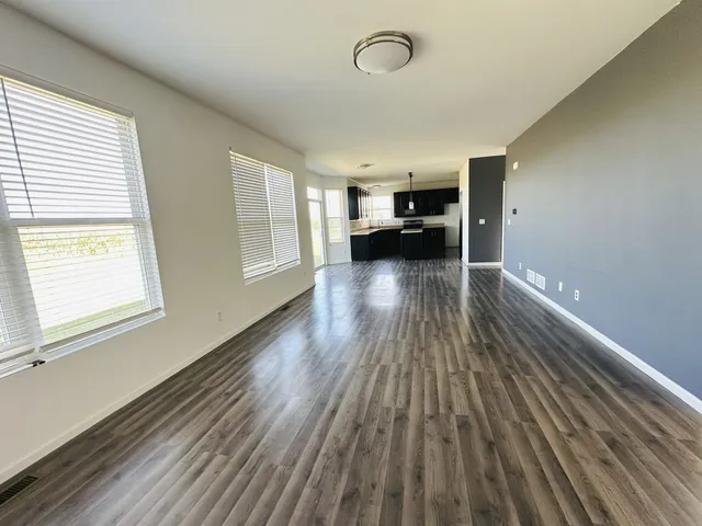 a kitchen with a sink and wooden floor
