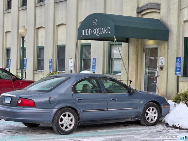 a front view of a house with a parking space