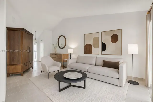 a living room with furniture and a wall painting