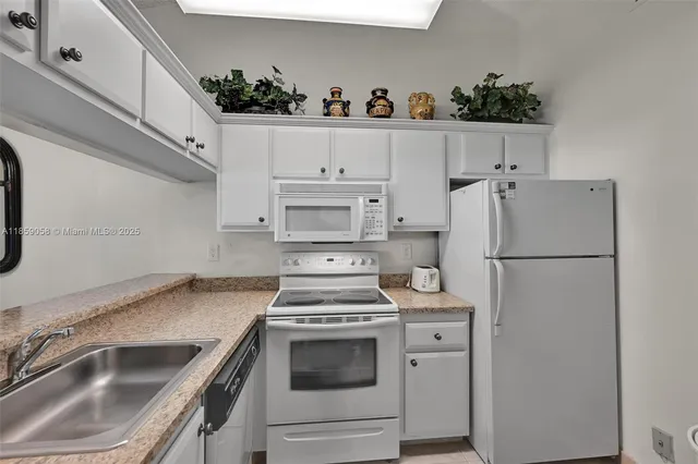 a kitchen with a sink stove and refrigerator