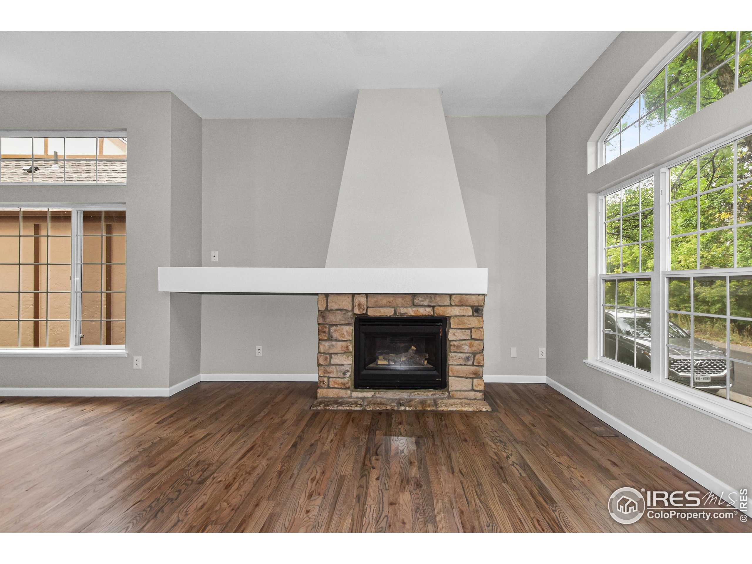 1680 Foxbrook Way Fort Collins, CO 80526 - Photo 12 of 42 a view of an empty room with wooden floor and a window