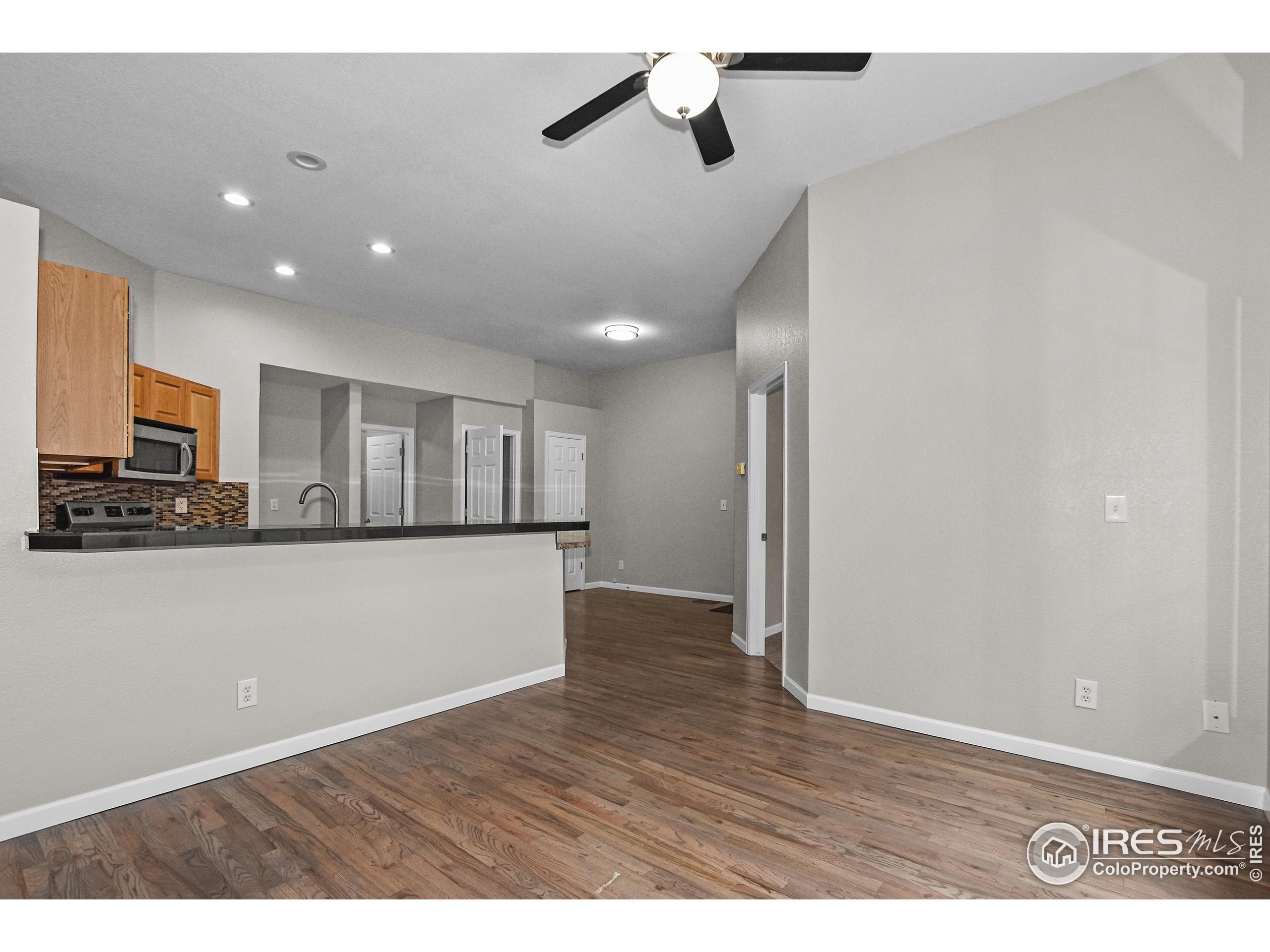 1680 Foxbrook Way Fort Collins, CO 80526 - Photo 14 of 42 a view of empty room with wooden floor