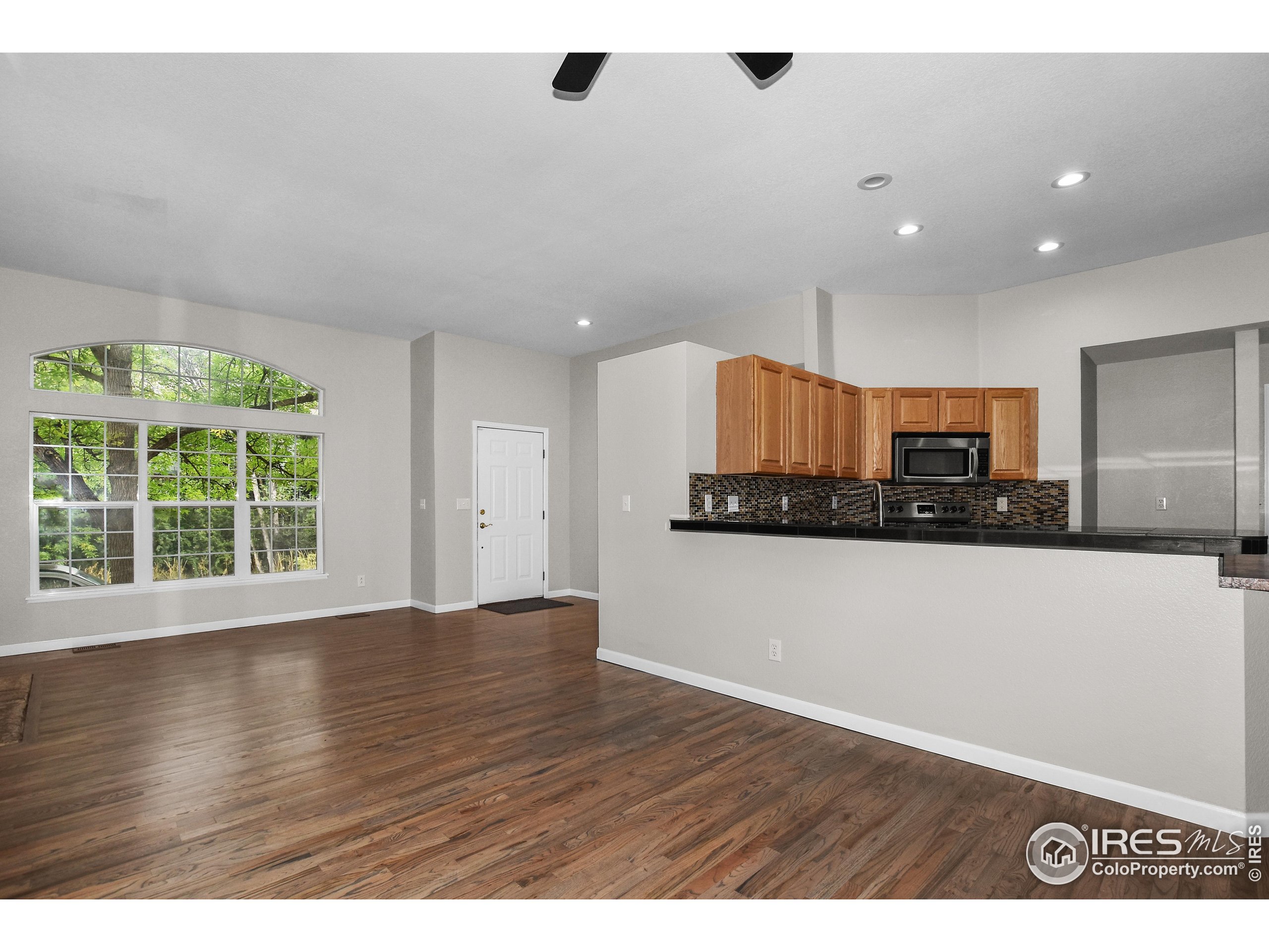 1680 Foxbrook Way Fort Collins, CO 80526 - Photo 16 of 42 a view of kitchen with stainless steel appliances wooden floor and large window