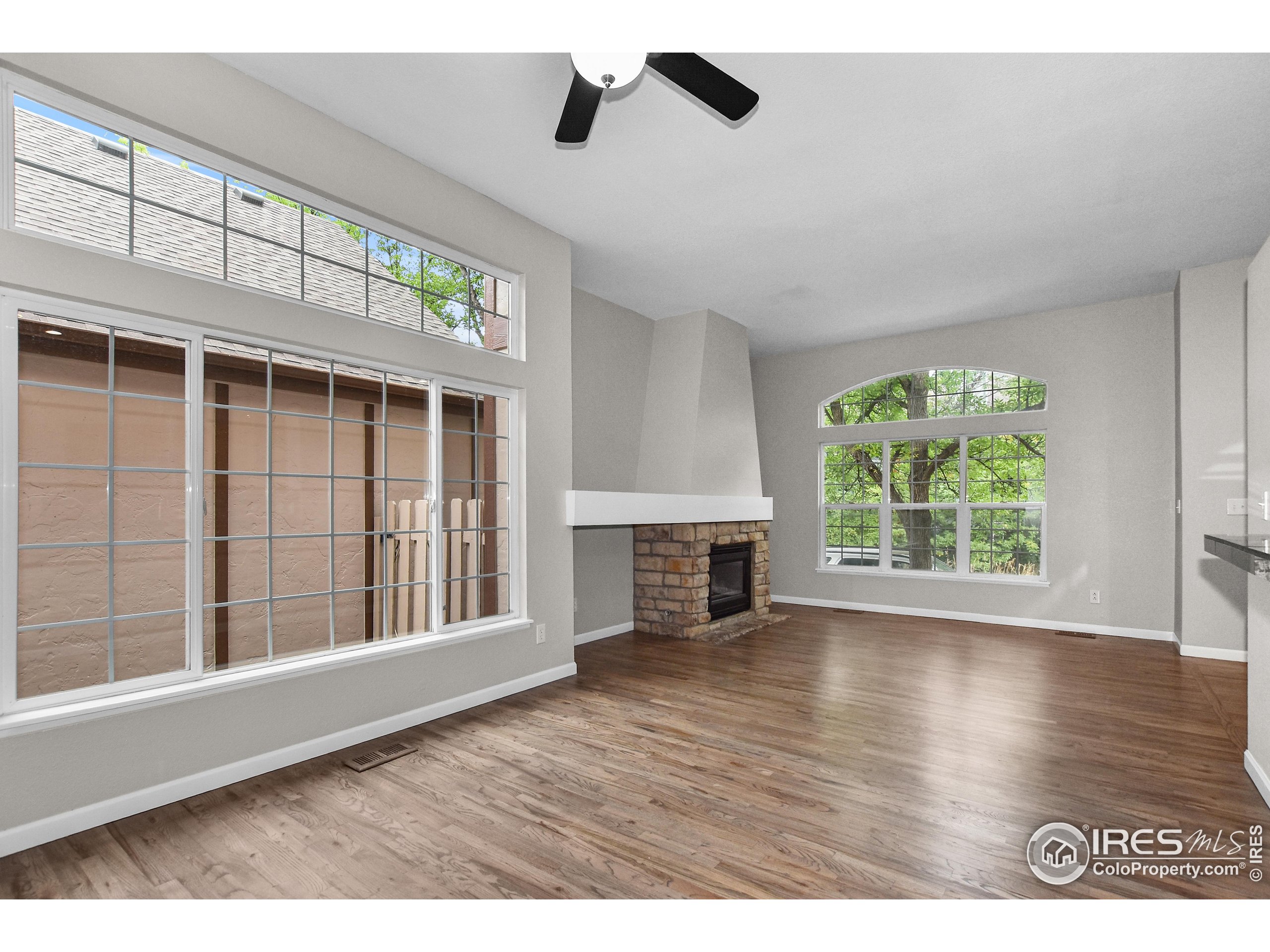 1680 Foxbrook Way Fort Collins, CO 80526 - Photo 17 of 42 a view of an empty room with wooden floor and a window