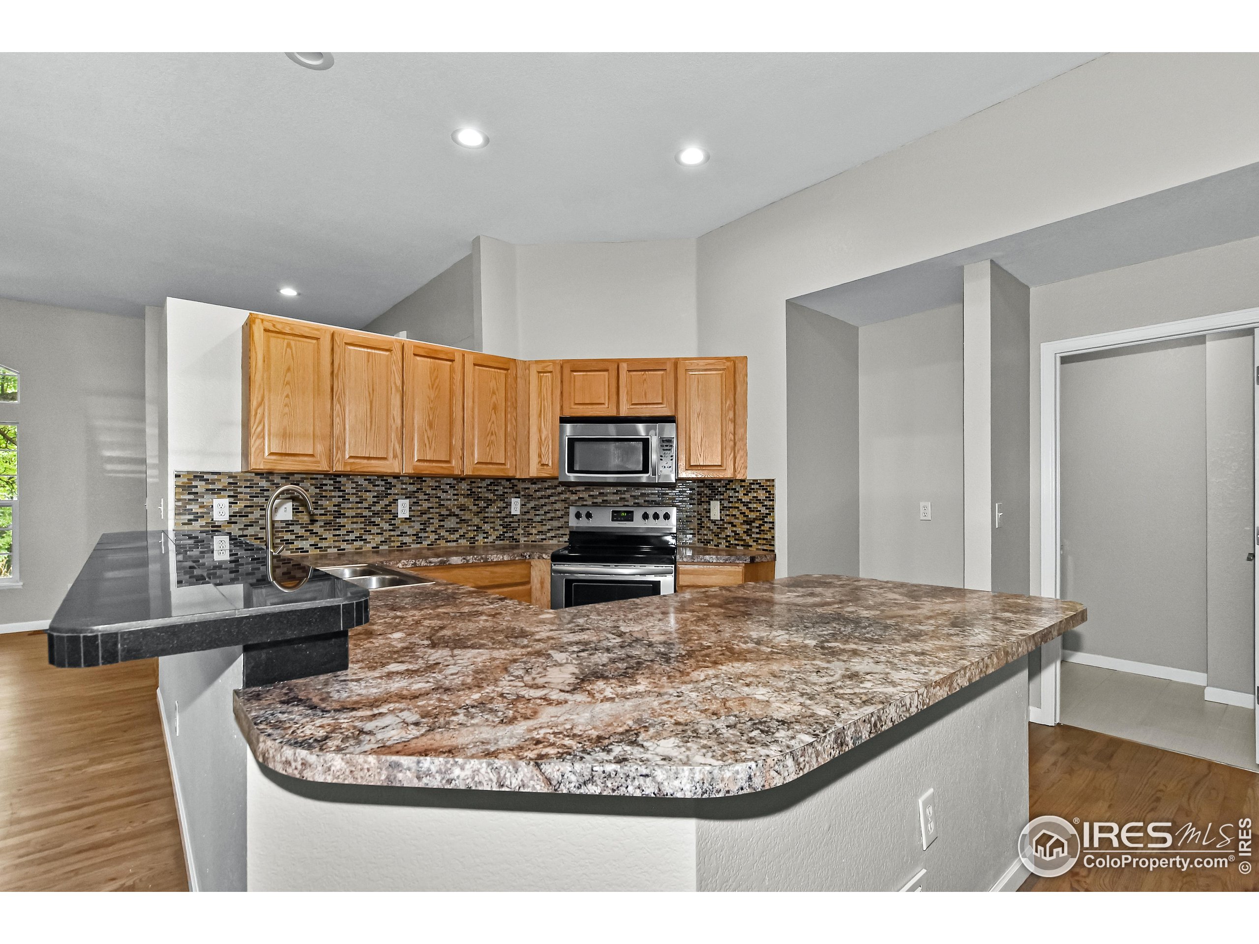 1680 Foxbrook Way Fort Collins, CO 80526 - Photo 18 of 42 a kitchen with a stove and a microwave