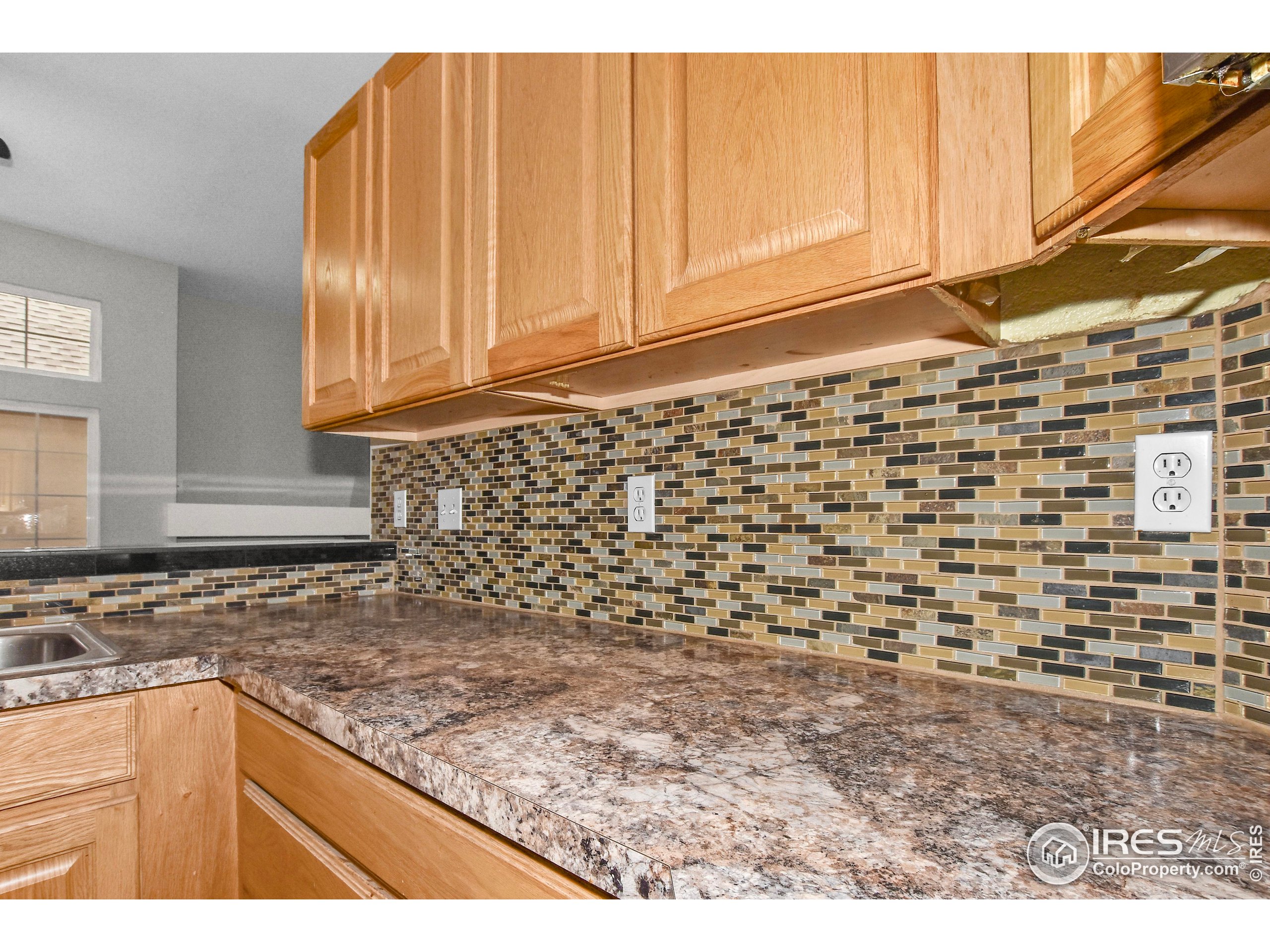 1680 Foxbrook Way Fort Collins, CO 80526 - Photo 20 of 42 a kitchen with a sink and cabinets