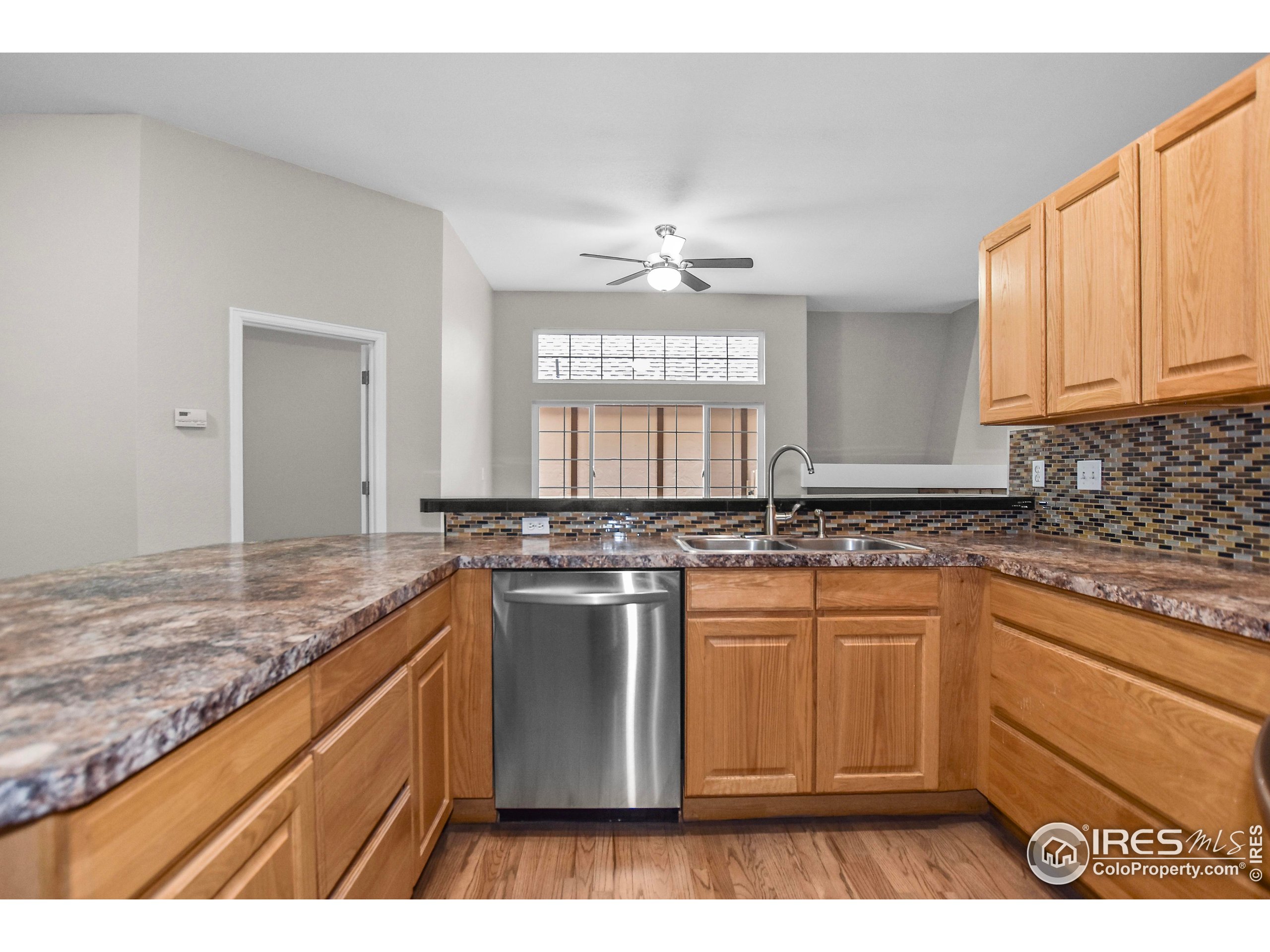 1680 Foxbrook Way Fort Collins, CO 80526 - Photo 22 of 42 a kitchen with stainless steel appliances granite countertop a stove a sink and a microwave