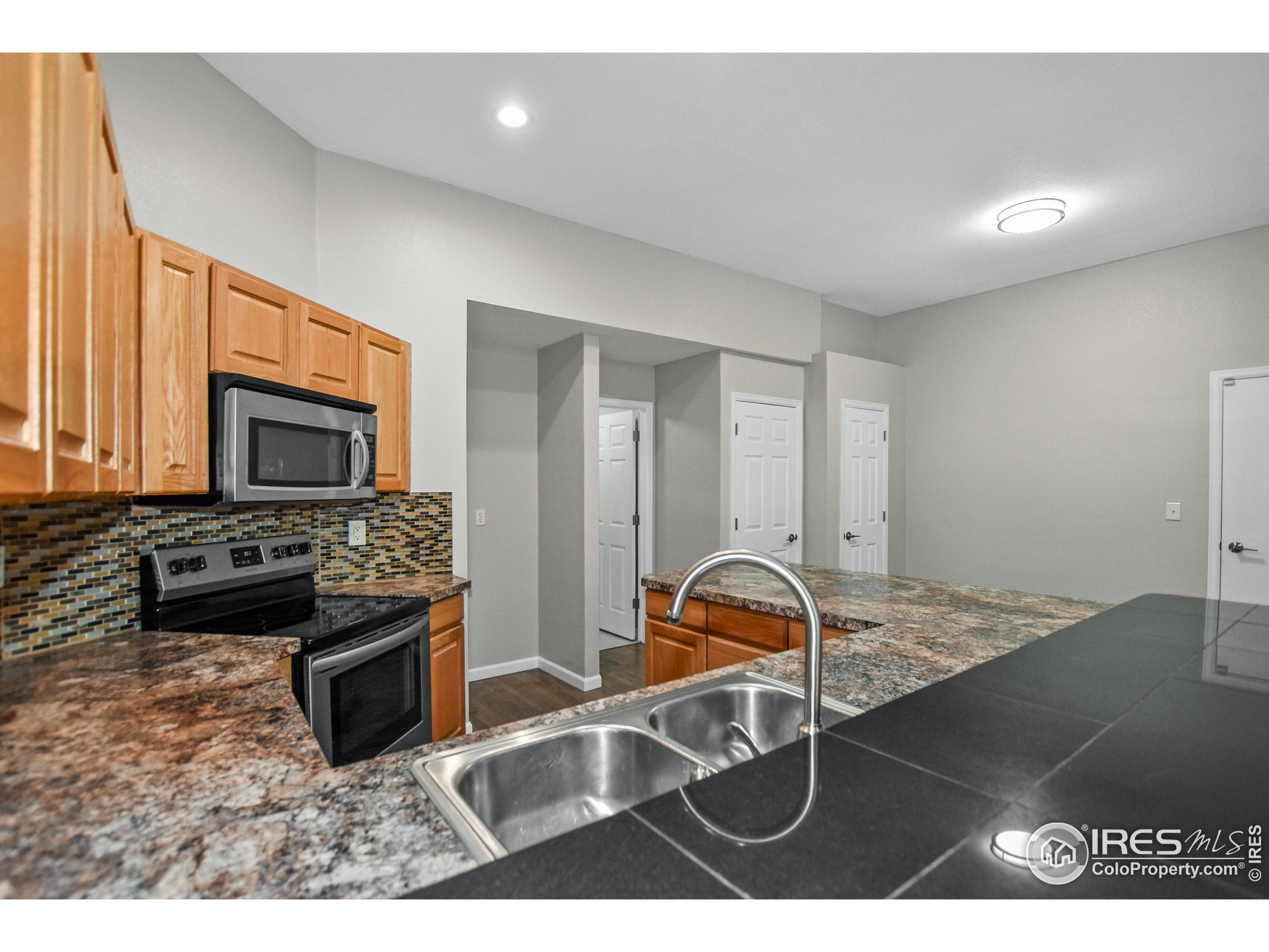 1680 Foxbrook Way Fort Collins, CO 80526 - Photo 24 of 42 a living room with furniture a flat screen tv and a fireplace