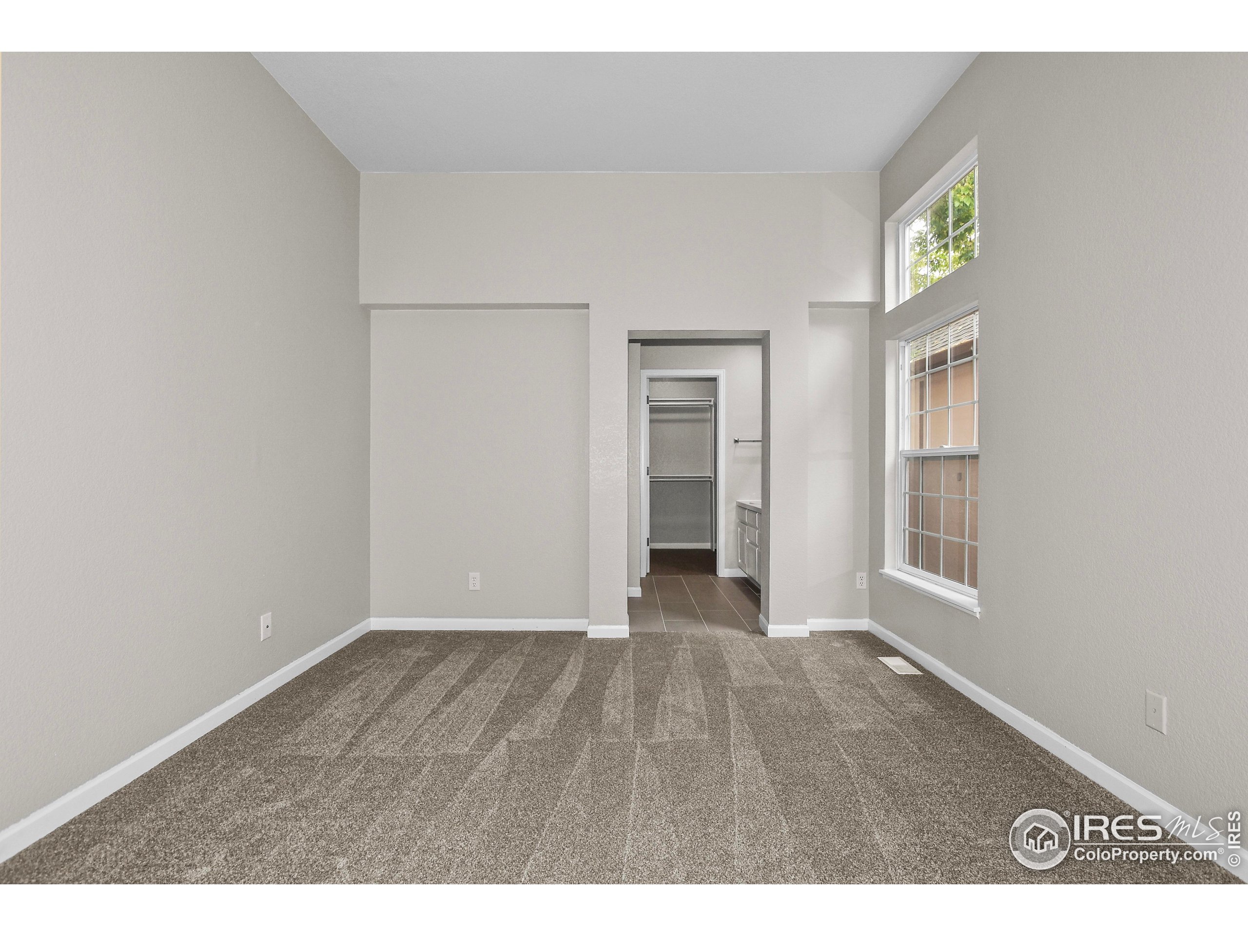 1680 Foxbrook Way Fort Collins, CO 80526 - Photo 28 of 42 a view of an empty room with wooden floor and windows
