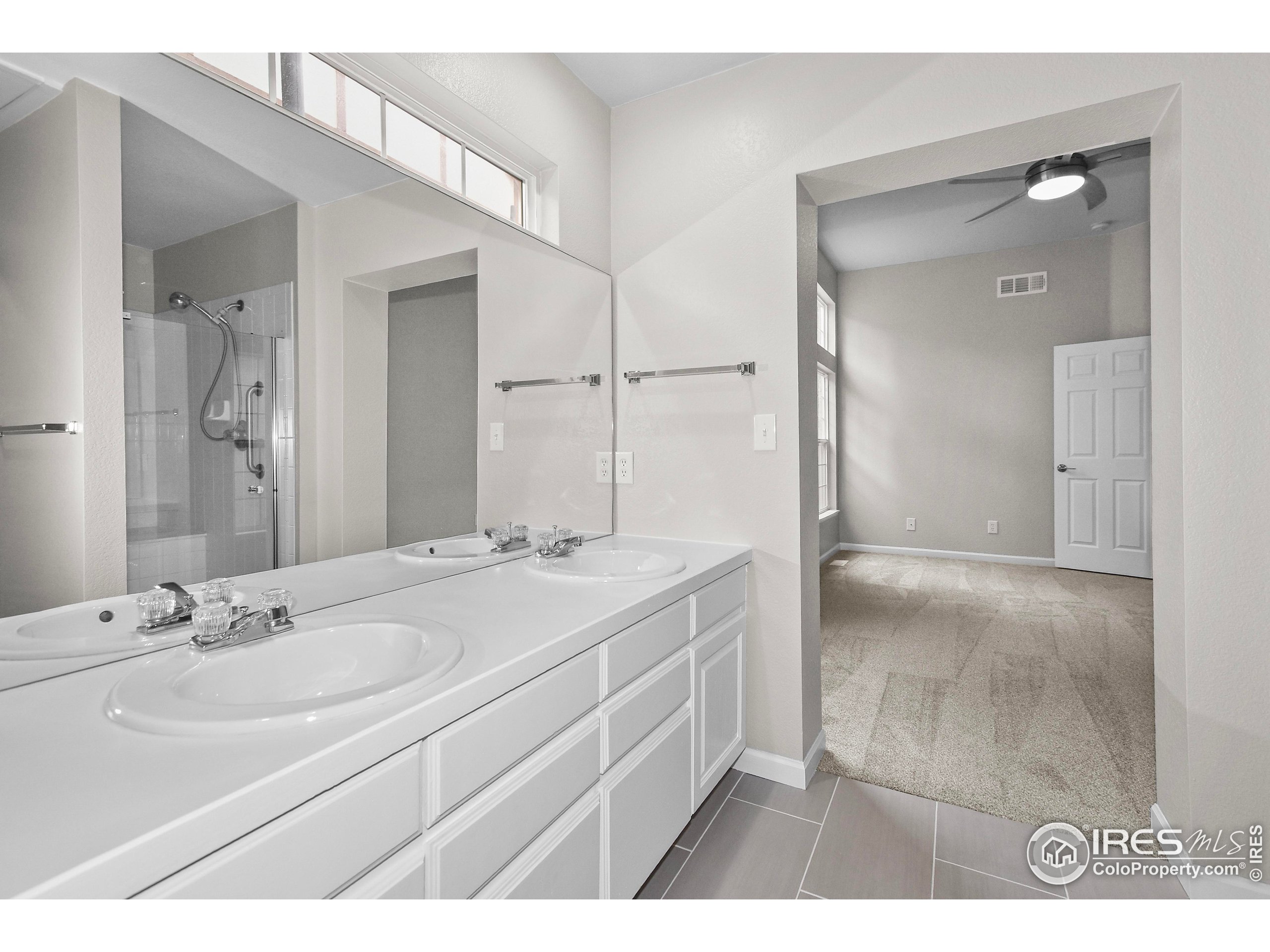 1680 Foxbrook Way Fort Collins, CO 80526 - Photo 30 of 42 a bathroom with a sink and a mirror