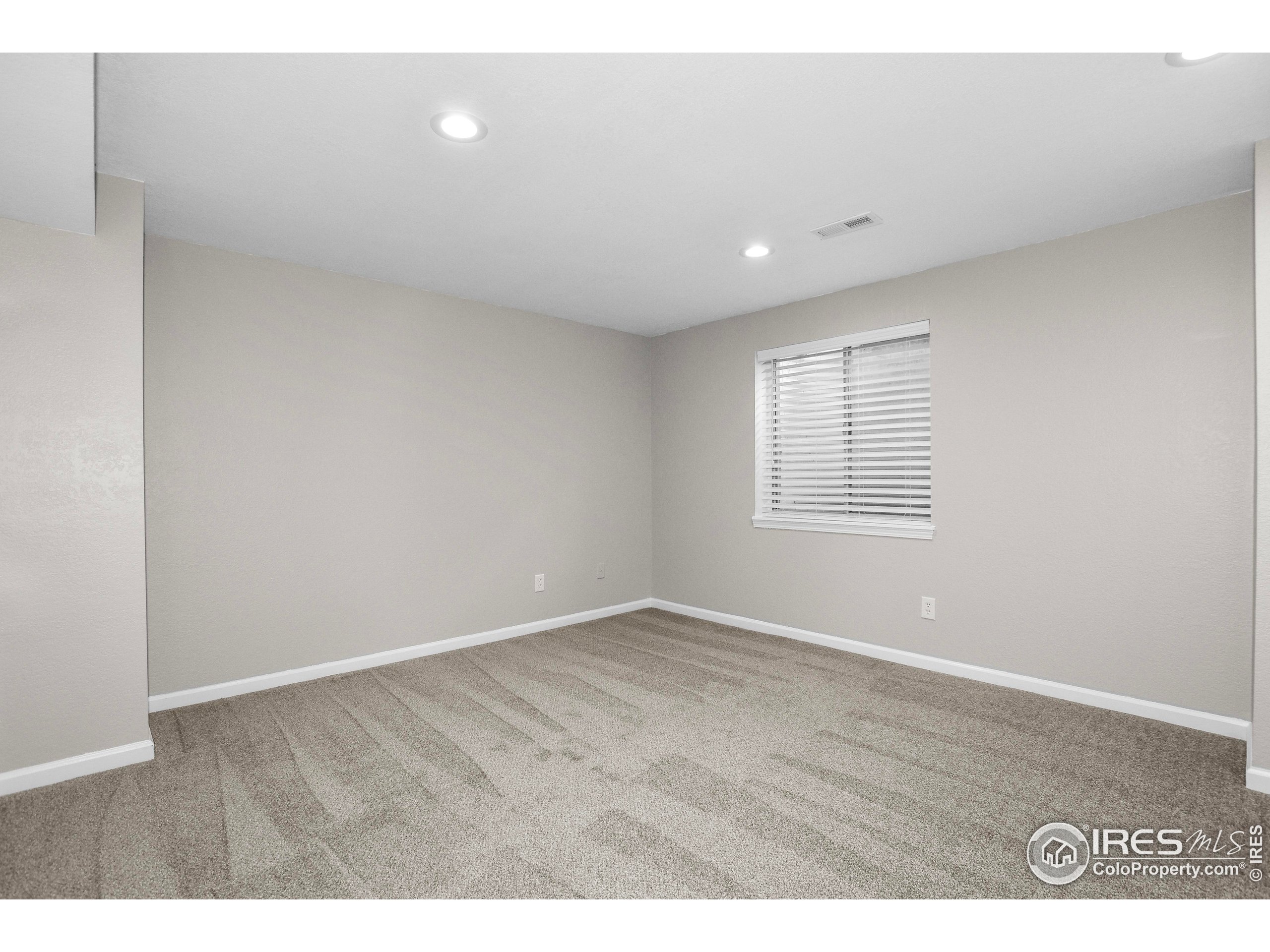 1680 Foxbrook Way Fort Collins, CO 80526 - Photo 33 of 42 a view of an empty room with wooden floor and a window