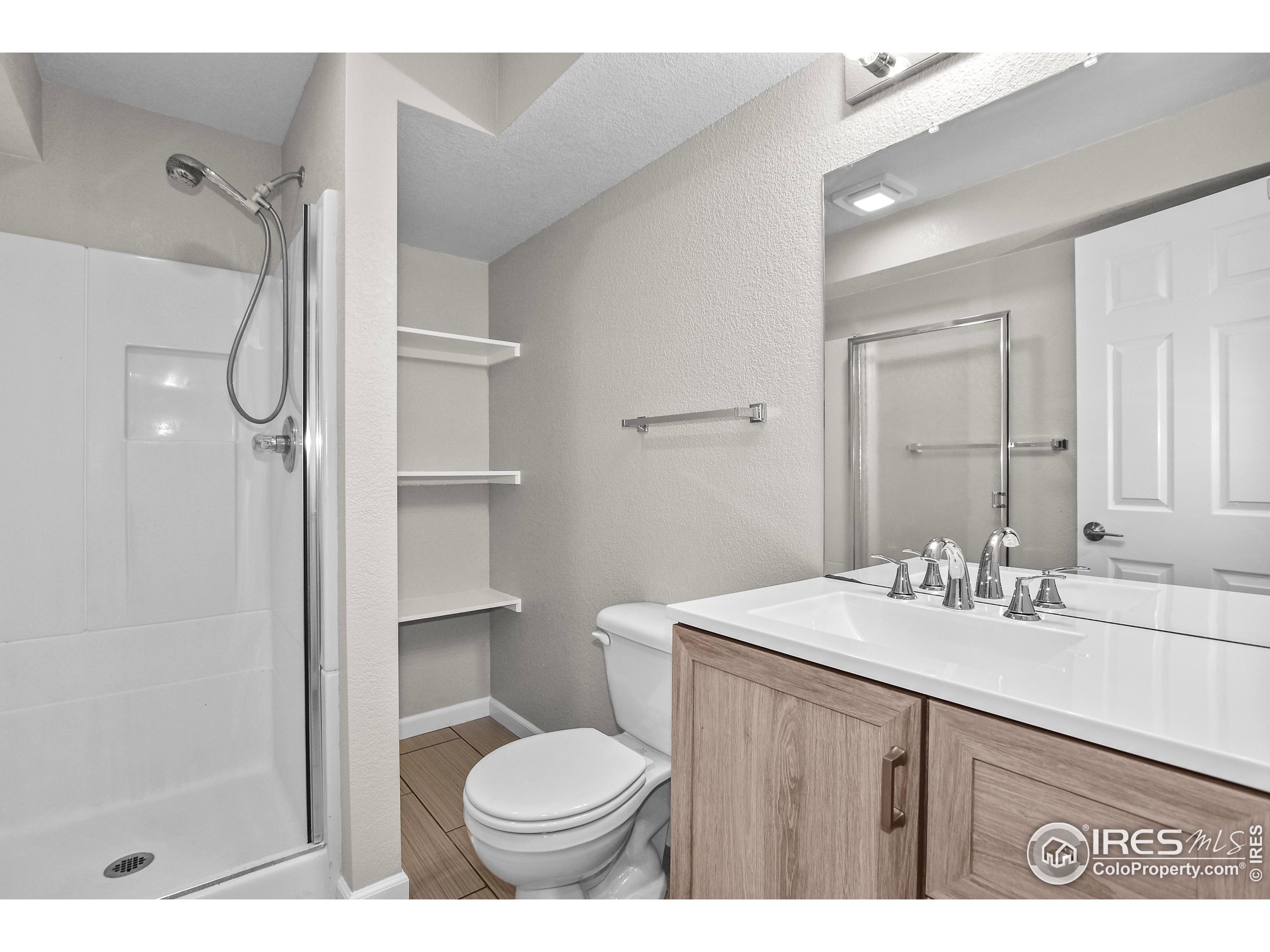 1680 Foxbrook Way Fort Collins, CO 80526 - Photo 36 of 42 a bathroom with a sink toilet a mirror and shower