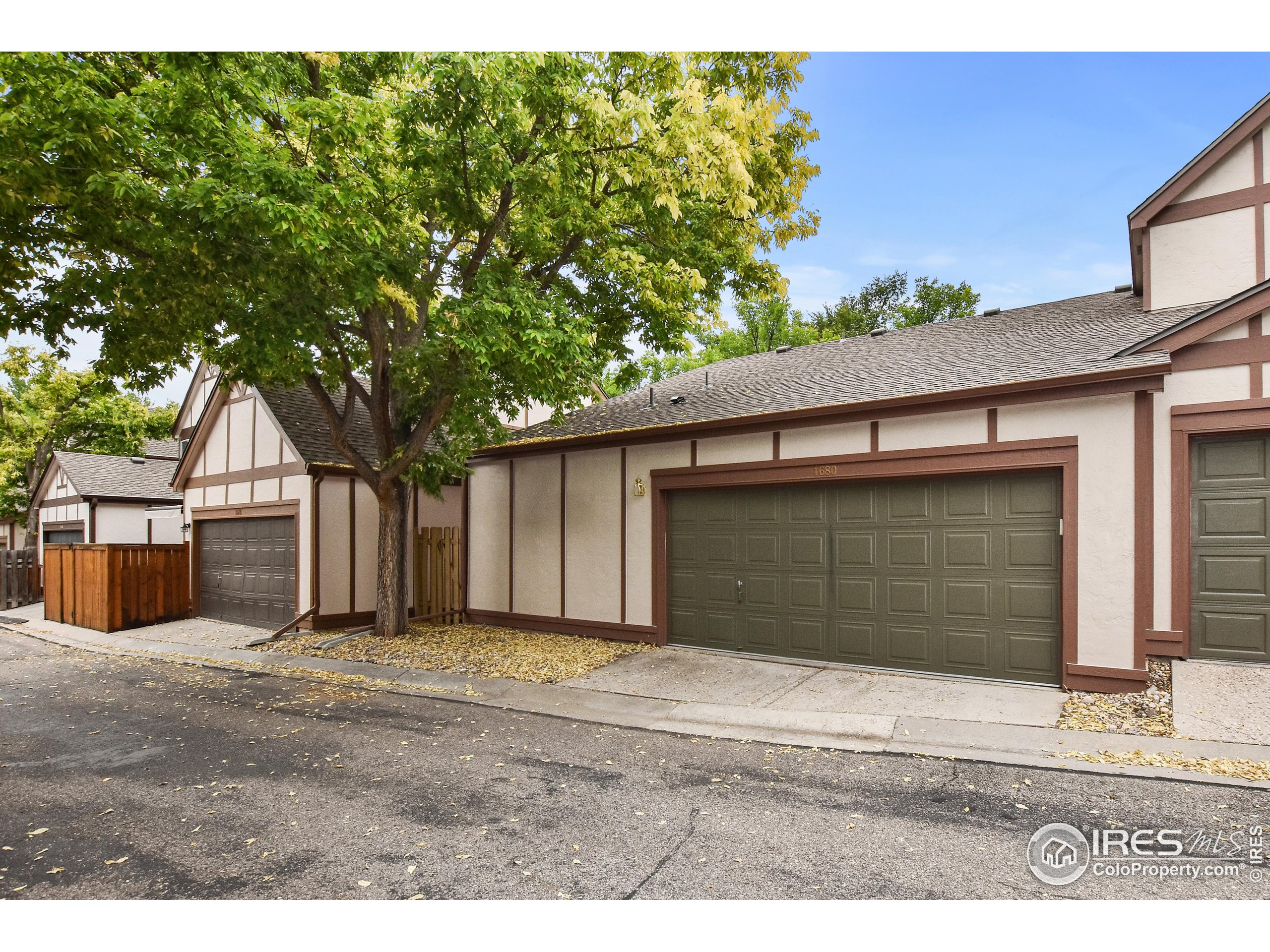 1680 Foxbrook Way Fort Collins, CO 80526 - Photo 37 of 42 a front view of a house with a yard and garage